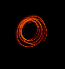 Light wave trail path, vibrant neon gold color in abstract swirls on a black background