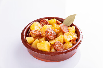 Fototapeta na wymiar Potatoes stew with chorizo, patatas a la riojana, on white background 