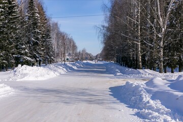 Winter snowy road in the village in russia