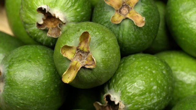 Acca sellowiana fruit (feijoa) rotation background. Close up