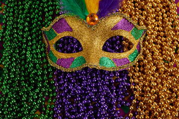 Mardi Gras Mask and colorful Mardi Gras Beads Background