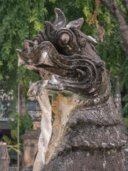 Close-up view of a chinthe or singha, a traditional lion guardian and protector at ancient Wat Pa Pao Shan buddhist temple, Chiang Mai, Thailand
