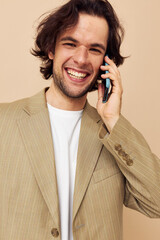 handsome man in a suit posing emotions talking on the phone isolated background