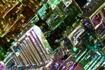 Synthetic bismuth (Bismuthum) crystal with rainbow oxide film close up, fantastic abstract...