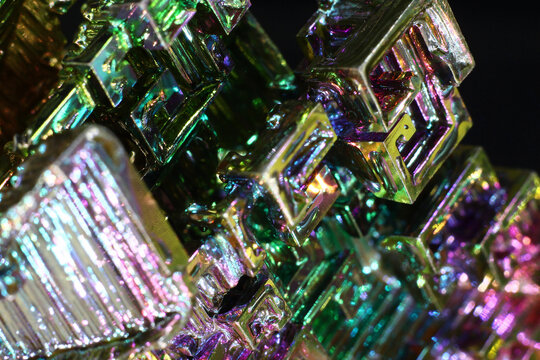 Synthetic bismuth (Bismuthum) crystal with rainbow oxide film close up, fantastic abstract background