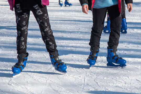 Bibbiano, December 2021. Legs and skates on a small skating rink in the town square