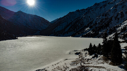 mountain lake, alpine lake, top view, drone, mountains, winter in mountains, sun, forest