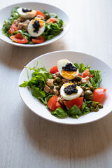 top view of bowls of fresh salad with eggs and caviar