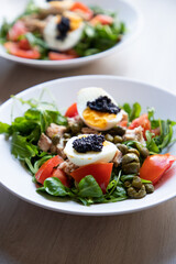 top view of bowls of fresh salad with eggs and caviar