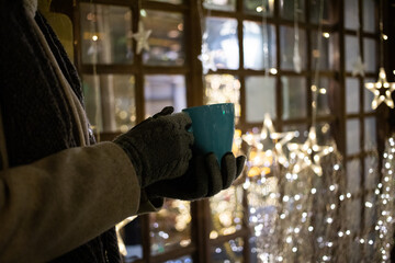 woman drinking mulled wine or hot tea at Christmas market
