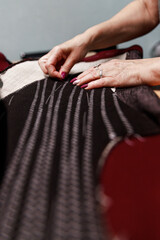 Obraz premium women's hands with scissors create a composition together with fabric, atelier