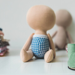 Close-up view on the creative process of sewing doll, details of doll cloth sewing machine on the table background. High quality photo