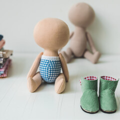 Close-up view on the creative process of sewing doll, details of doll cloth sewing machine on the table background. High quality photo