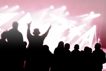Fototapeta na wymiar Crowd at a music concert, audience raising hands up