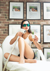 a woman in a laser hair removal studio with a maniple and a cactus in her hand as a symbol of hair...