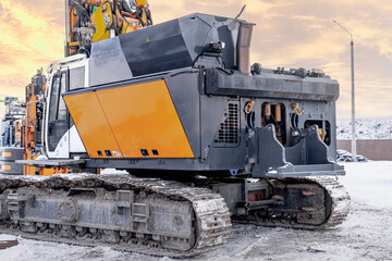 A powerful drilling rig for piling in winter at a construction site. Operation of the drilling rig in northern conditions. Pile foundations. Bored piles. Close-up.