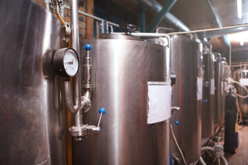 Selective focus on pressure gauge on a steel tank at beer brewery, copy space