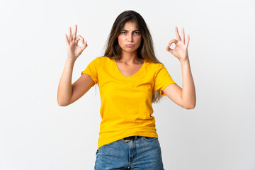 Young caucasian woman isolated on white background in zen pose