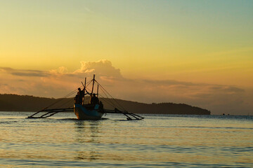 Traditional fishermen at sunrise. Waiting for the tide to flow. Ready to head for the fishing nets.  Over fishing of the very small fish means poor catches . No fish, no money, no food. 