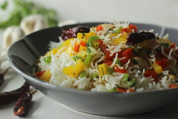 Rice with sauteed bell peppers. Steamed basmati rice tossed with sauteed bell peppers flavoured with red chillies and garlic
