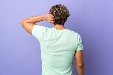 English man over isolated purple background in back position and thinking