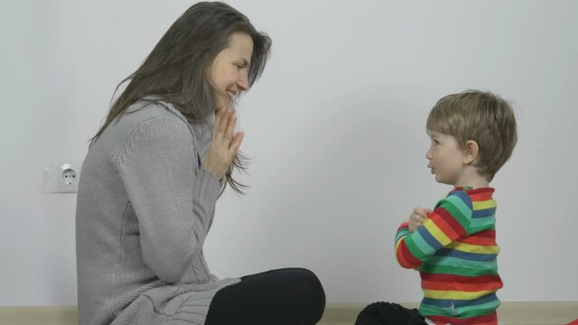 Little boy making confessions to his mother, family communication