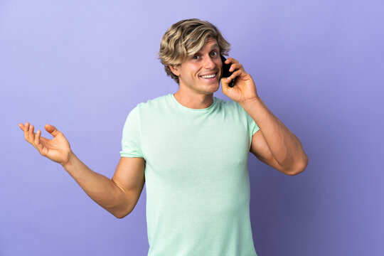 English man over isolated purple background keeping a conversation with the mobile phone with someone
