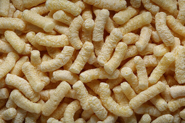Yellow corn sticks close-up top view. Background and textures.