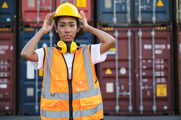 Portrait engineer businesswoman with container background