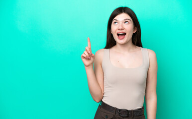 Fototapeta premium Young Russian woman isolated on green background pointing up and surprised