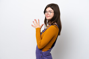 Fototapeta premium Young Russian woman isolated on blue background scheming something