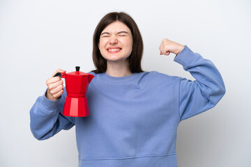 Young Russian woman holding coffee pot isolated on white background doing strong gesture