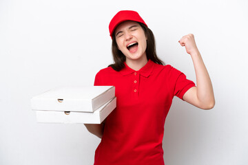 Young Russian pizza delivery picking up pizza boxes isolated on white background celebrating a...