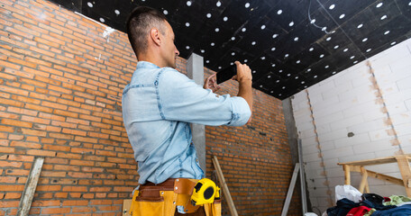 Builder projecting future interior standing at the construction site