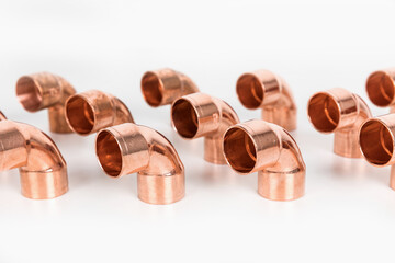 Group of fittings on a white background. Copper fittings for pipe connections. Technical basis for heating companies.