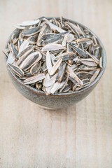 top view leftovers of eaten sunflower seed pods in a bowl on table