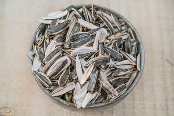 top view leftovers of eaten sunflower seed pods in a bowl