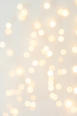 Background with abstract golden sparkling christmas lights. Bokeh effect. Defocused. Template for...