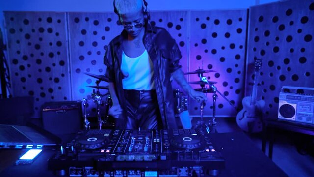 DJ playing music with mixer player in house studio - Youth musician entertainment concept