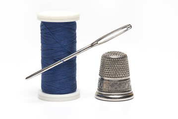 roll sewing thread needle thimble white background