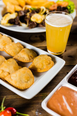 Colorful Food Appetizer Starts Snacks Fresh Delicious Menu Recipe Meal Meat Chicken Fries Fish Seafood Beer on a wooden table