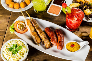 Colorful Food Appetizer Starts Snacks Fresh Delicious Menu Recipe Meal Meat Chicken Fries Fish Seafood Beer on a wooden table