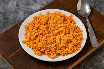 Bulgur pilaf on a dark background. Close-up of Turkish food Bulgur Pilav in a ceramic plate