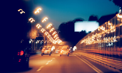 Blurry unfocused background with cars on the highway at night.