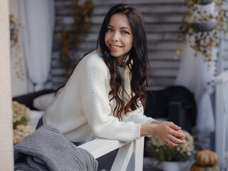 woman spends free time outdoors near house on terrace