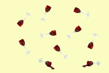 Trendy dishes pattern made with wine glasses. Several wine glasses on a light yellow background.