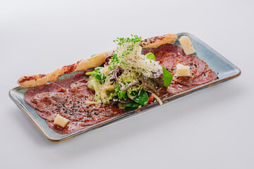 A veal carpaccio dish with fennel and arugula and young zucchini