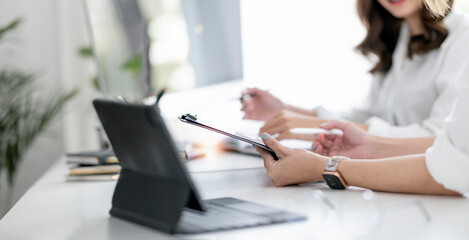 Cropped view of young business team discussing the plan together in modern office room.