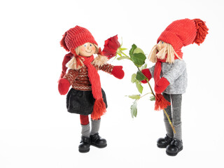 Dolls, a boy and a girl with flowers, make congratulations.On a white background .Concept .Postcard for Valentine's Day, Friend's Day, February 14, mother's day