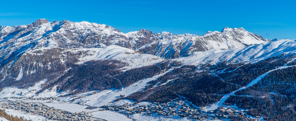 Panoramic view of the Italian Alps with the ski resort town of Livigno seen from the slopes